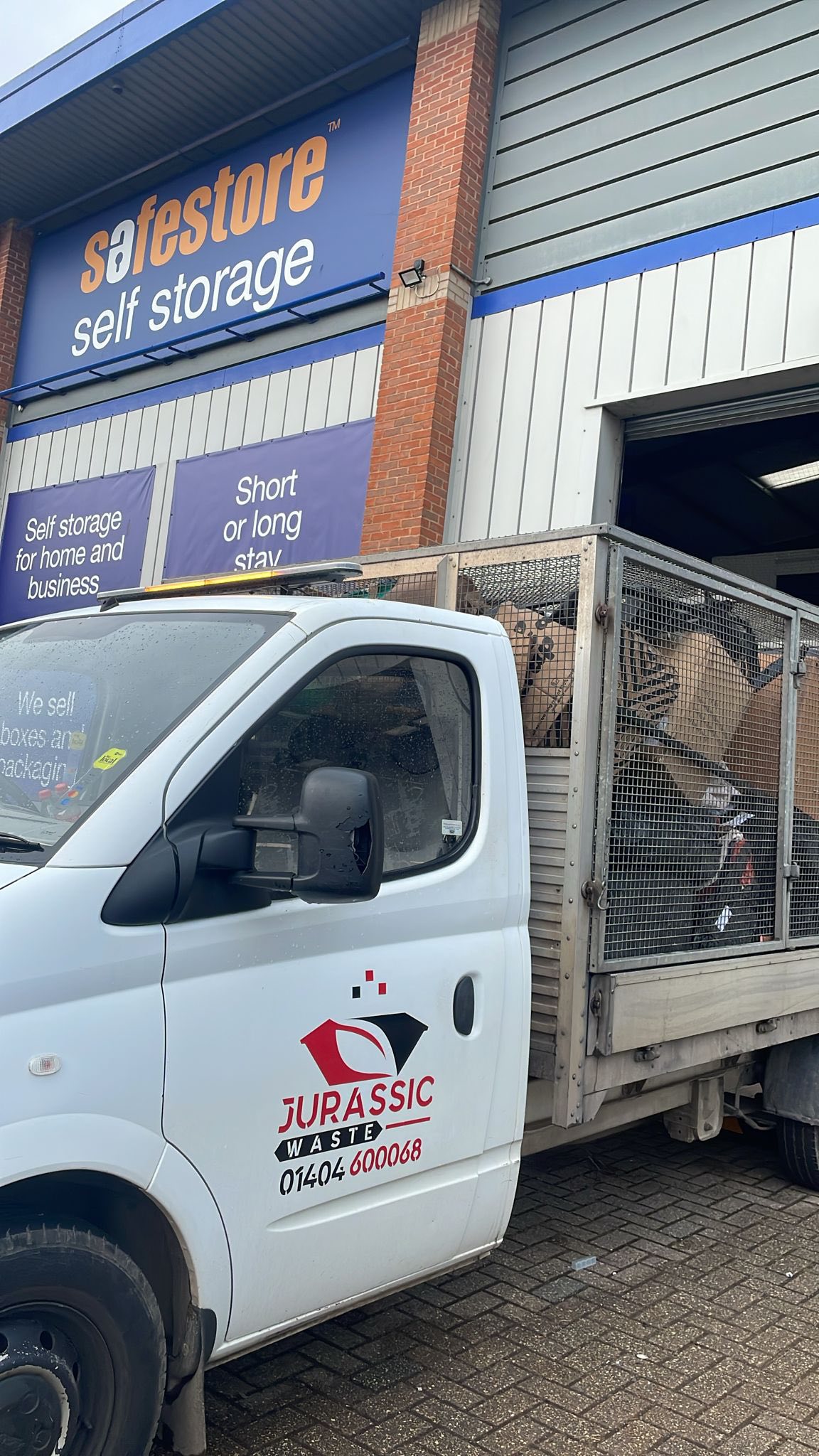Two-person team loading waste into a van